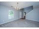 Cozy living room features neutral paint, carpeted floor, and window for natural light at 113 Lebsl Ct, Summerville, SC 29483