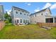 Expansive backyard with patio, seating area, grill, and garden beds at 113 Osprey Ridge Ln, Summerville, SC 29483