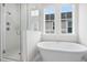 Bright modern bathroom featuring a glass-enclosed shower and free-standing soaking tub at 113 Osprey Ridge Ln, Summerville, SC 29483