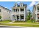 Beautiful two-story home with a traditional facade, highlighted by a charming porch and dormer windows at 113 Osprey Ridge Ln, Summerville, SC 29483