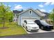 Exterior view of the house featuring a garage and two parked cars at 113 Osprey Ridge Ln, Summerville, SC 29483