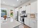 Well-appointed kitchen boasting white cabinetry, stainless steel appliances, and a quartz countertop island at 113 Osprey Ridge Ln, Summerville, SC 29483