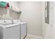 Bright laundry room with white washer and dryer, wire shelving, and fresh towels at 113 Osprey Ridge Ln, Summerville, SC 29483