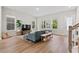 Inviting living room with a large sectional, hardwood floors, and ample windows for natural light at 113 Osprey Ridge Ln, Summerville, SC 29483