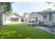 Lush backyard featuring a deck and patio area, complemented by a well-maintained lawn and multiple outbuildings at 1151 Camellia Dr, Mount Pleasant, SC 29464