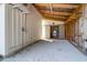 Barn interior with gravel floor, wooden support beams, white siding and open entry at 1151 Camellia Dr, Mount Pleasant, SC 29464