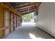 Open barn interior showing gravel, wooden trusses, and white siding at 1151 Camellia Dr, Mount Pleasant, SC 29464