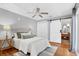 Inviting bedroom featuring hardwood floors, a ceiling fan, and a barn door to the bathroom at 1151 Camellia Dr, Mount Pleasant, SC 29464