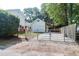 Gated driveway leading to a white house and a wooden fence in a wooded area at 1151 Camellia Dr, Mount Pleasant, SC 29464