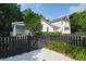 Charming two-story home with white siding, black fence, and well-manicured landscaping offering curb appeal at 1151 Camellia Dr, Mount Pleasant, SC 29464