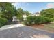 Home exterior showcasing a well-maintained asphalt driveway and lush greenery, providing a serene and inviting entrance at 1151 Camellia Dr, Mount Pleasant, SC 29464