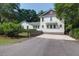 Charming home exterior with well-kept lawn and a paved driveway, surrounded by lush trees at 1151 Camellia Dr, Mount Pleasant, SC 29464