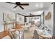 Open-concept living room with wood floors, ceiling fans, neutral decor, and seamless flow to adjacent dining and kitchen at 1151 Camellia Dr, Mount Pleasant, SC 29464