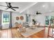Bright and airy living room showcasing wood floors, ceiling fans, and comfortable seating, creating a welcoming atmosphere at 1151 Camellia Dr, Mount Pleasant, SC 29464