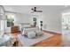 Light-filled main bedroom boasts hardwood floors, a ceiling fan, and an ensuite bathroom at 1151 Camellia Dr, Mount Pleasant, SC 29464