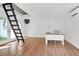 Bright home office featuring wood floors, white walls, desk and ladder for loft access at 1151 Camellia Dr, Mount Pleasant, SC 29464