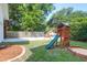 Backyard playground featuring wooden playset with slide, swings, and a sandbox for outdoor fun at 1151 Camellia Dr, Mount Pleasant, SC 29464