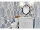 Chic powder room with patterned wallpaper, modern fixtures and a vanity sink at 1151 Camellia Dr, Mount Pleasant, SC 29464