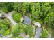 An aerial view of a beautiful home featuring a private backyard pool, surrounded by lush greenery and mature trees at 127 White Pine Way, Summerville, SC 29485