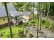 Backyard with a sunroom, patio area, detached garage and landscaped yard with mature trees at 127 White Pine Way, Summerville, SC 29485