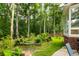 Lush, green backyard featuring mature plantings, a sunroom, and a patio at 127 White Pine Way, Summerville, SC 29485