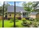 View of a home's backyard featuring a sunroom and patio area with seating and a lush yard at 127 White Pine Way, Summerville, SC 29485