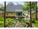 Backyard showcasing a well-maintained lawn, sunroom with patio, and mature trees at 127 White Pine Way, Summerville, SC 29485