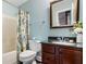 Charming bathroom featuring a vanity with dark countertop, a tub with a decorative curtain, and stylish decor at 127 White Pine Way, Summerville, SC 29485