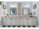 Bathroom vanity with double sinks, white cabinets and hardware, and a framed mirror at 127 White Pine Way, Summerville, SC 29485