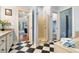 Bright bathroom features black and white tile floors, and a glass shower door at 127 White Pine Way, Summerville, SC 29485