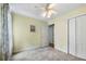 Bright bedroom with a ceiling fan, closet, neutral carpeting, and a connecting door to the adjacent room at 127 White Pine Way, Summerville, SC 29485