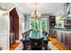 Elegant dining room with large table, chandelier, and views of the outdoor greenery at 127 White Pine Way, Summerville, SC 29485
