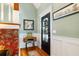 Charming entryway with unique wainscoting, colorful wallpaper, and a decorative table at 127 White Pine Way, Summerville, SC 29485
