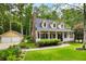 Beautiful yellow home with a cozy front porch, manicured lawn, and detached garage at 127 White Pine Way, Summerville, SC 29485