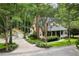 Charming two-story yellow home with a brick chimney, attached garage and a wraparound front porch at 127 White Pine Way, Summerville, SC 29485