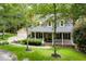 Inviting home with a charming front porch and a detached two car garage at 127 White Pine Way, Summerville, SC 29485