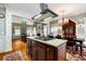 Spacious kitchen with a large island, granite countertops and views into the dining and living rooms at 127 White Pine Way, Summerville, SC 29485