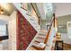 Elegant staircase with wooden steps, a carpet runner, and bright overhead light at 127 White Pine Way, Summerville, SC 29485