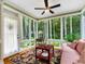 Cozy sunroom with plenty of natural light and views of the wooded backyard at 127 White Pine Way, Summerville, SC 29485