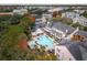 An aerial view of a community pool and spa surrounded by condos with balconies and colorful trees at 130 River Landing Dr # 8203, Charleston, SC 29492