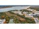 An aerial view of a condo community near marshland with an industrial skyline in the distance at 130 River Landing Dr # 8203, Charleston, SC 29492