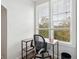 This home office features a desk and a chair with a view of the trees outside the window at 130 River Landing Dr # 8203, Charleston, SC 29492