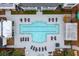 An aerial view of a community pool surrounded by lounge chairs and well-maintained landscaping at 130 River Landing Dr # 8203, Charleston, SC 29492