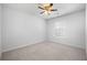 A well-lit bedroom featuring neutral walls, ceiling fan, and plush carpet at 1309 Berry Grove Dr, Summerville, SC 29485