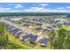 Beautiful aerial view of a neighborhood featuring a central lake and well-maintained homes with green lawns at 1384 Locals St, Summerville, SC 29485