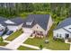 Aerial view of a charming home with manicured lawn and driveway, nestled between two similar houses at 1384 Locals St, Summerville, SC 29485