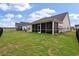 Spacious backyard features a screened porch, a fence, and well-maintained lawn at 1384 Locals St, Summerville, SC 29485