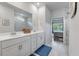 Bathroom featuring a double vanity, marble floors and a mirror that spans the length of the vanity at 1384 Locals St, Summerville, SC 29485