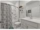 Traditional bathroom with floral curtain, vanity with a large mirror and shelves for storage at 1384 Locals St, Summerville, SC 29485