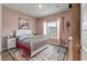 Cozy bedroom with a white bed frame, colorful rug, and a window with natural light at 1384 Locals St, Summerville, SC 29485